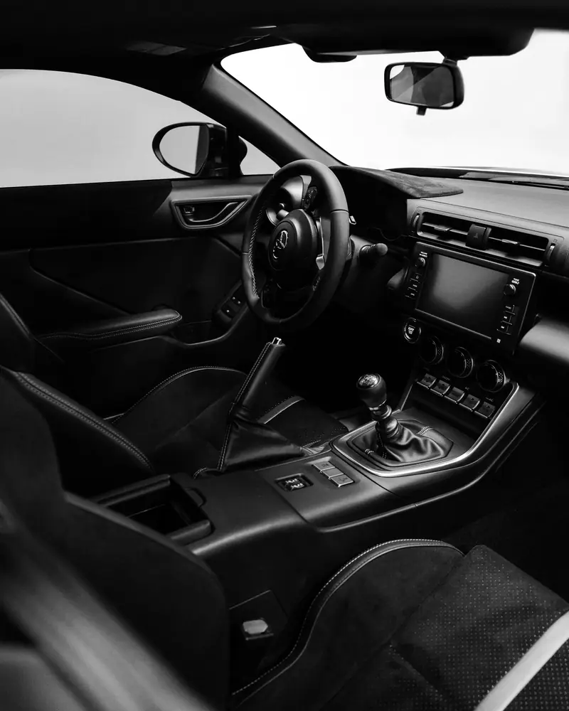 A clean modern cabin seen through the open driver's door